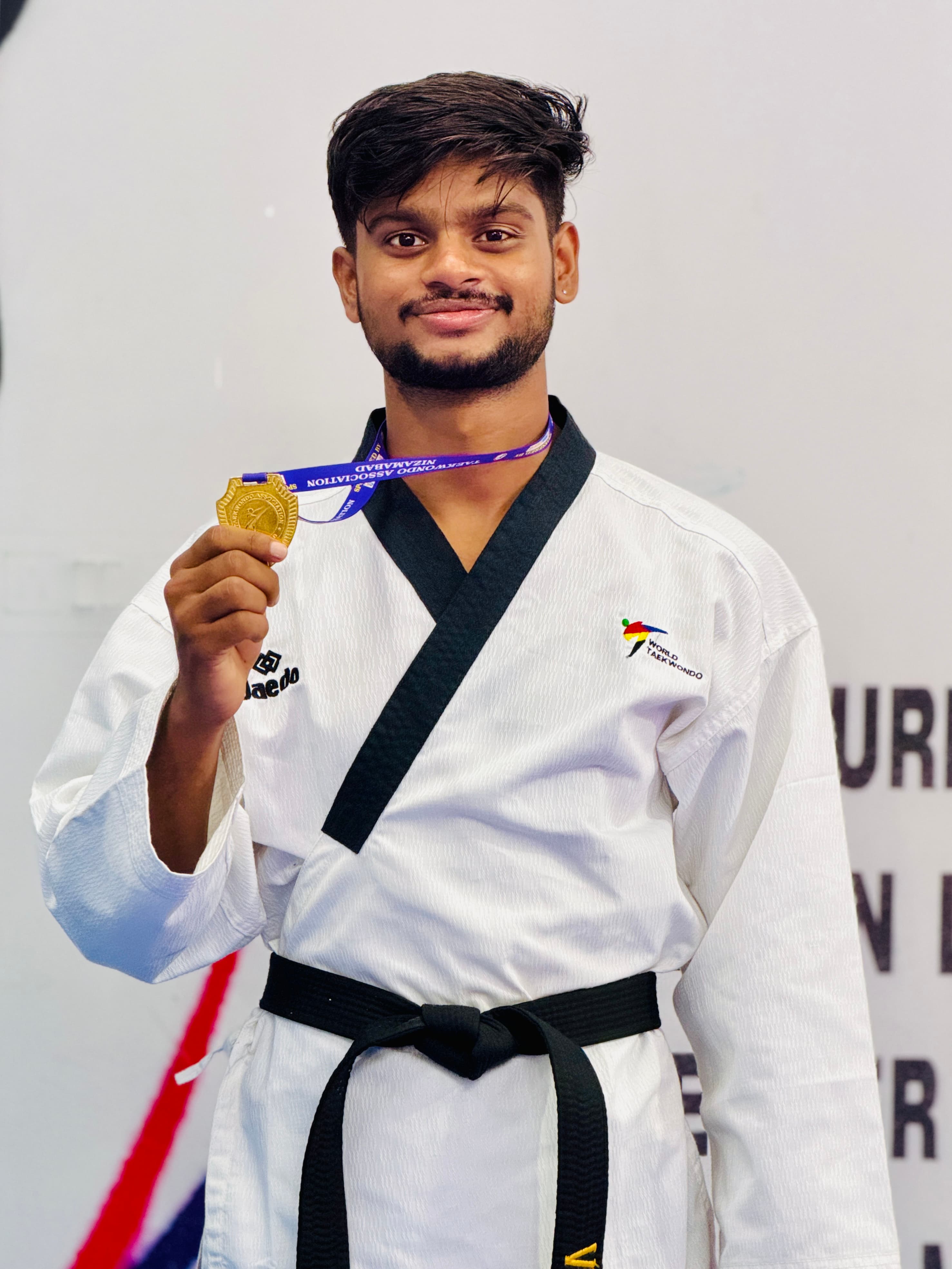Student athlete with a gold medal at a World Taekwondo event