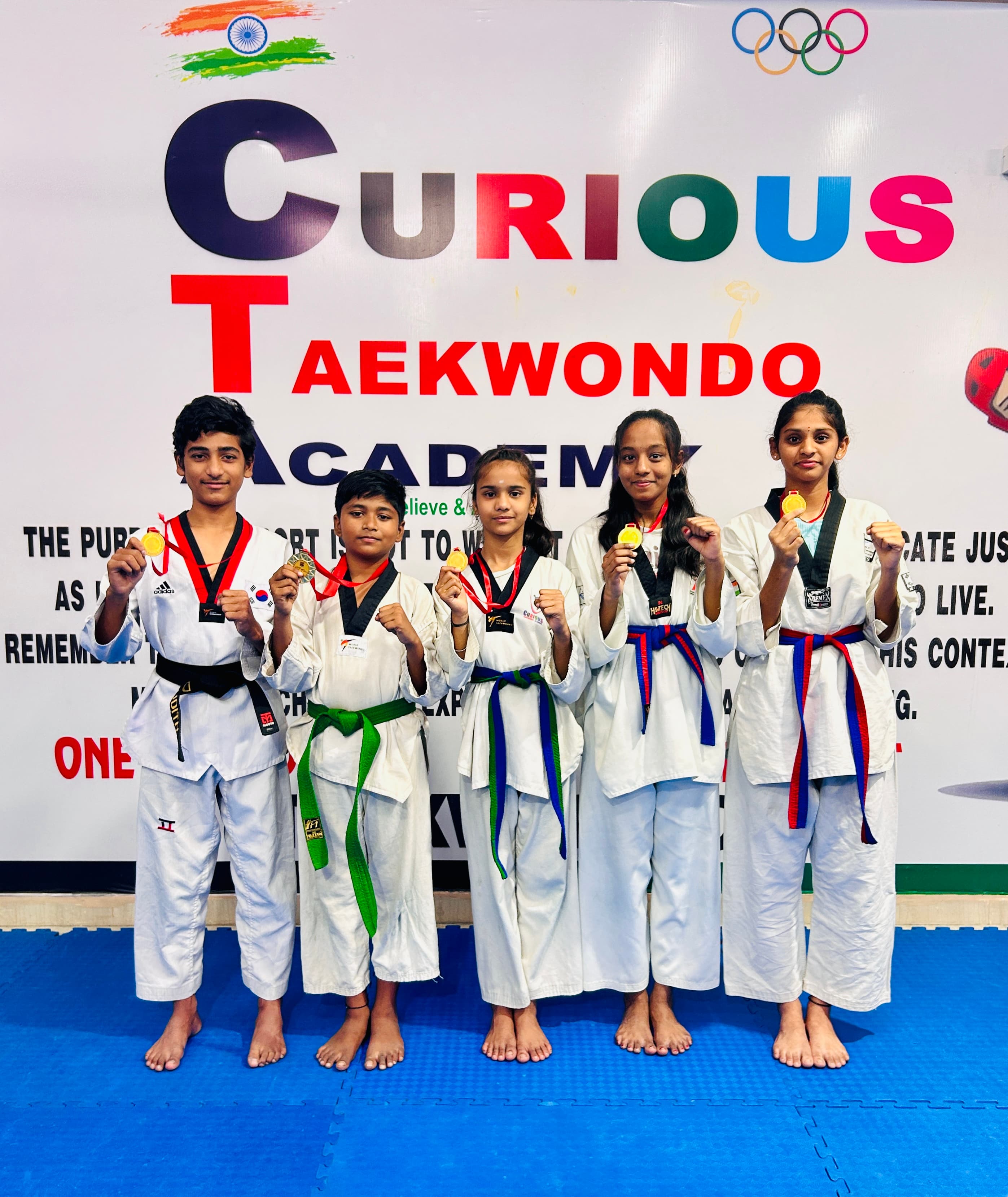 Students with gold medals at a Taekwondo championship